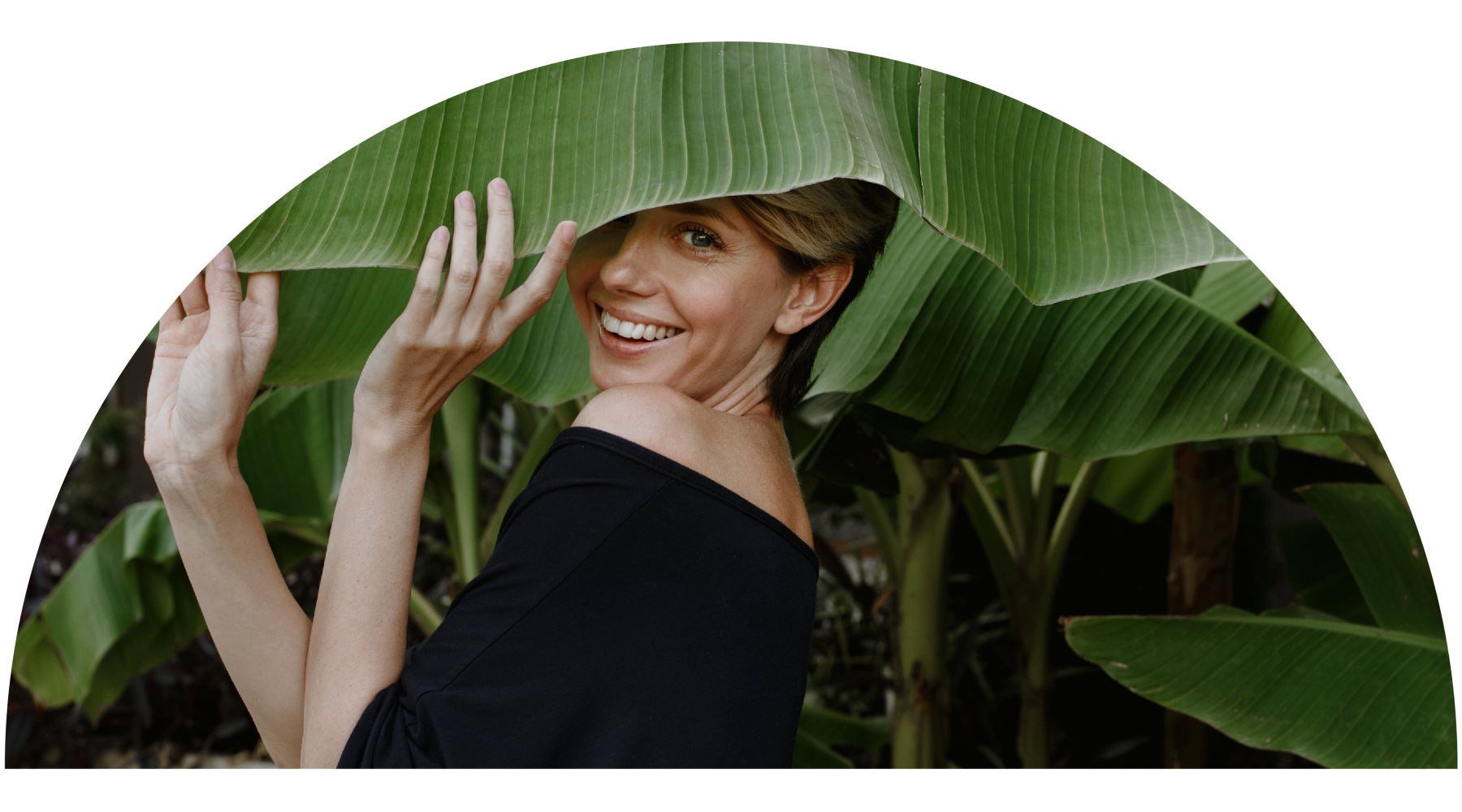 A beautiful community at the heart of all your passions a woman smiling with foliage