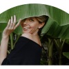a woman smiling with foliage