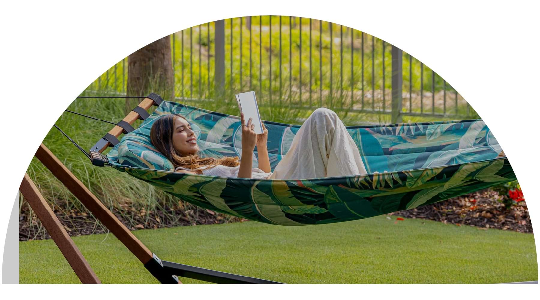 a woman smiling in a hammock
